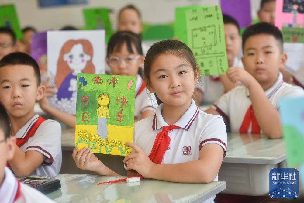 9月9日，在山东省青州市宏远学校，学生展示为老师绘制的肖像画。新华社发（王继林摄）