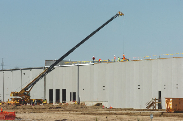 Construction crew inspects the roof.
