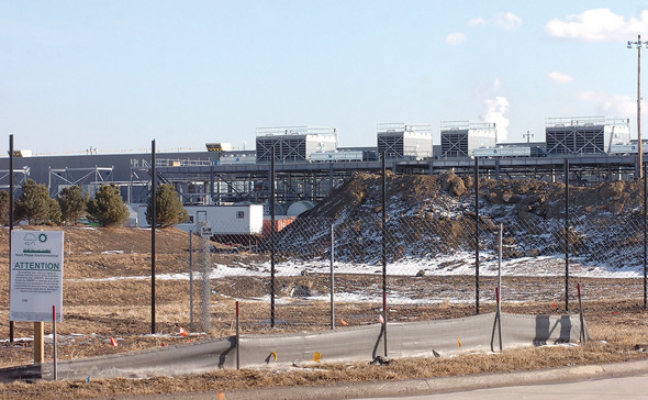 Dirt berm and rooftop cooling system as seen from entrance.